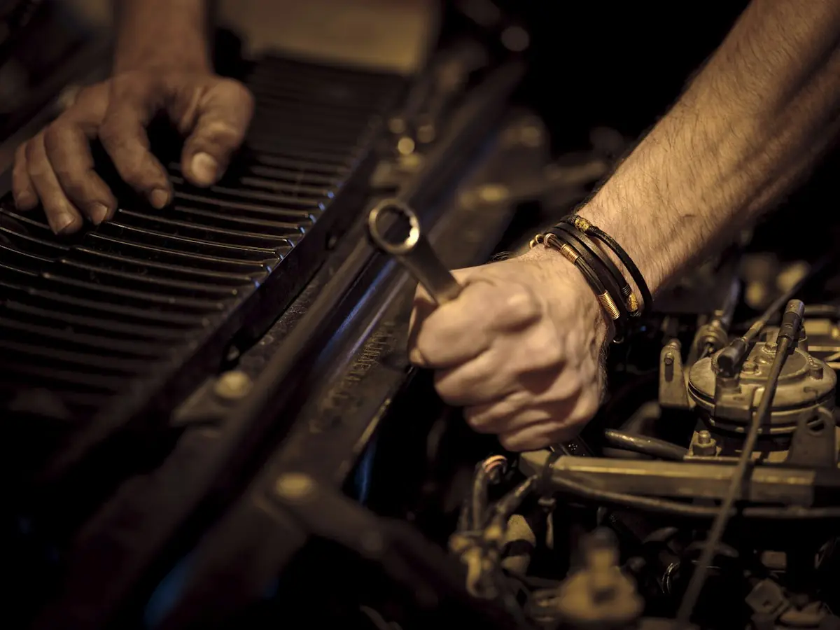 Hands tightening a part with a wrench